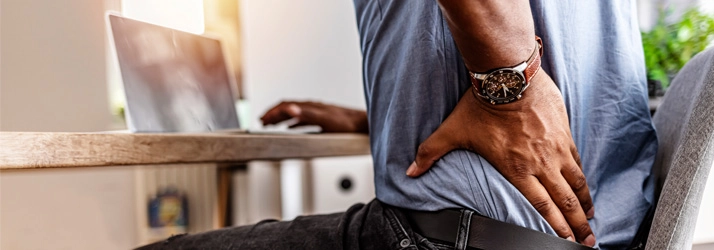 Chiropractic Lincoln NE Back Pain A man holding his lower back.